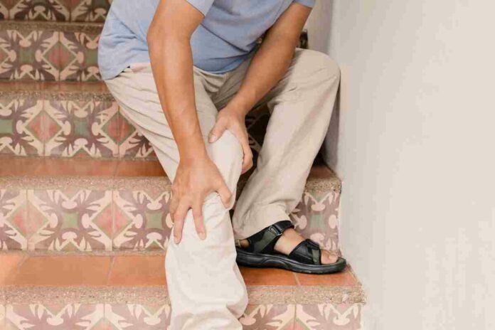 man massaging his leg